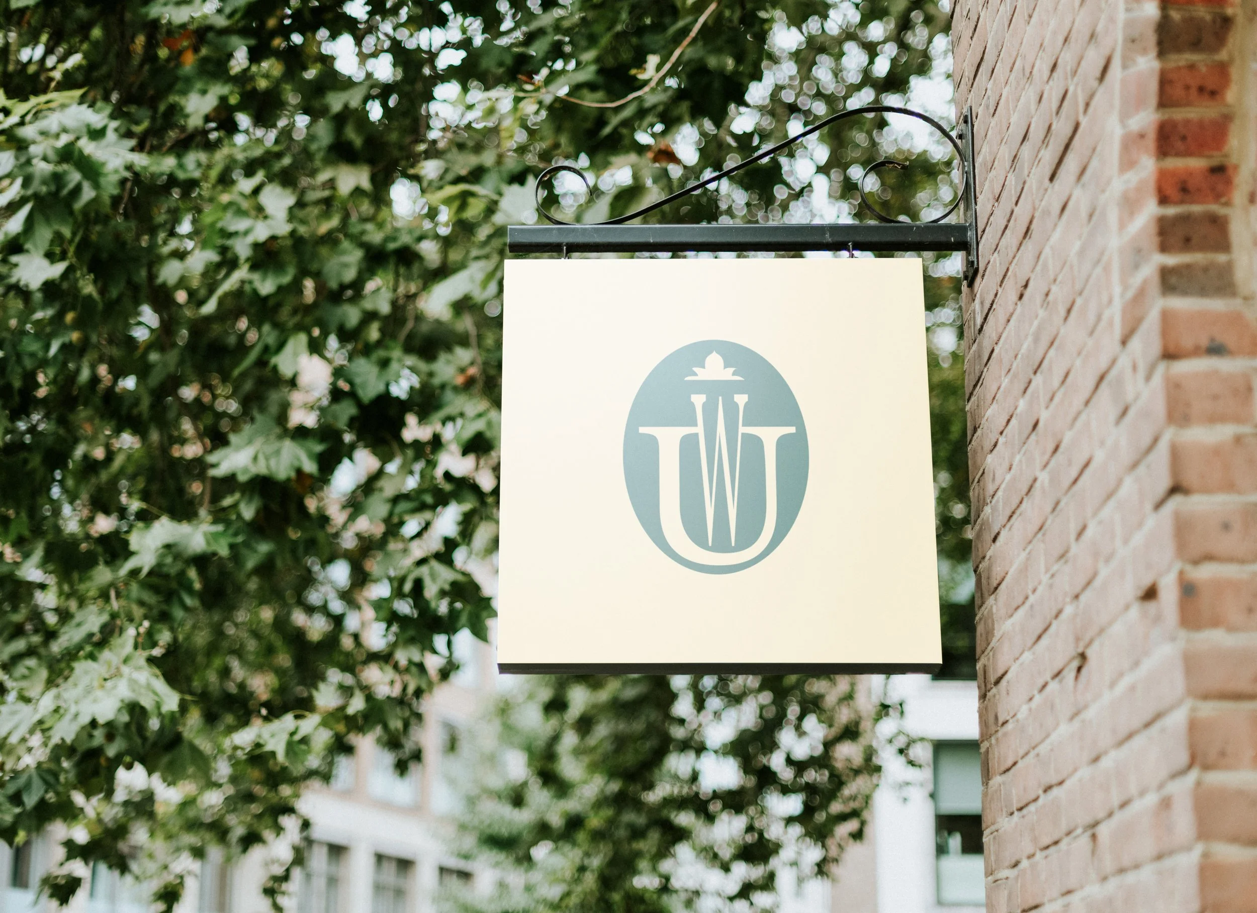 Hanging hotel sign with the Walk-Up monogram